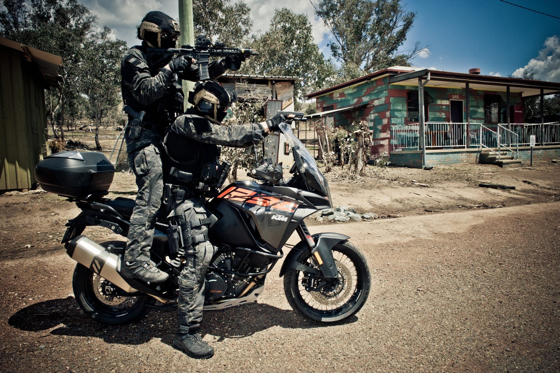 Two operators riding tactical motorcycles